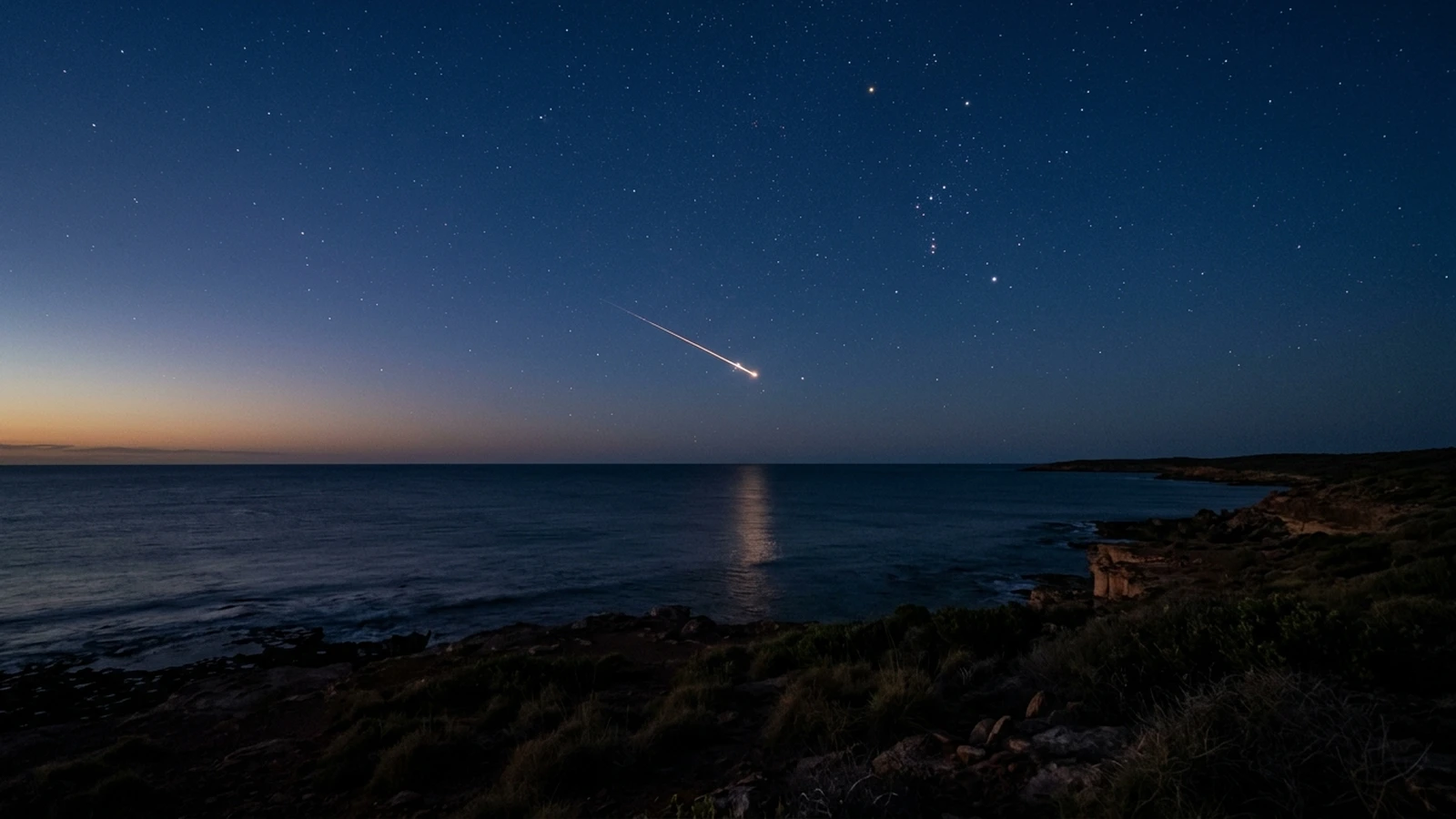 Illustration of a small fireball streaking over the Indian Ocean at dusk, seen from the north-west Australian coast