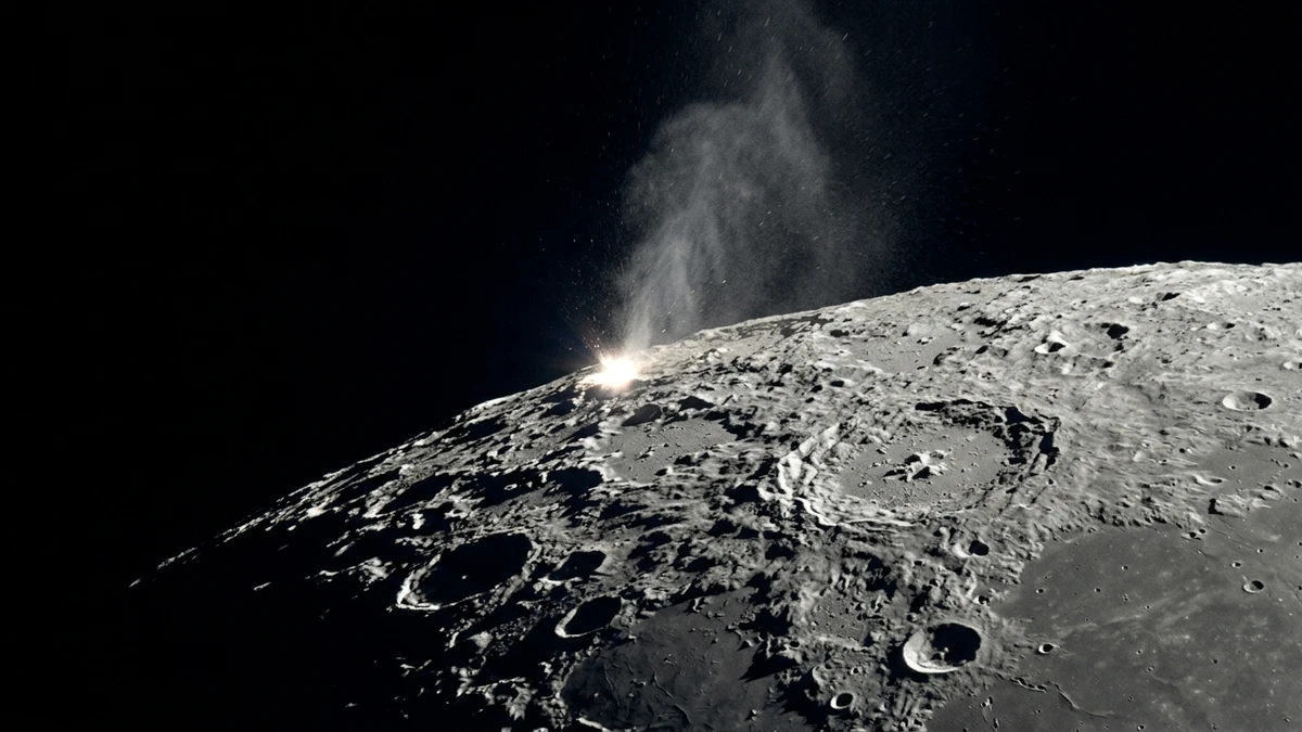 A bright flash and a rising plume of debris on the sunlit edge of the Moon, seen against the black of space