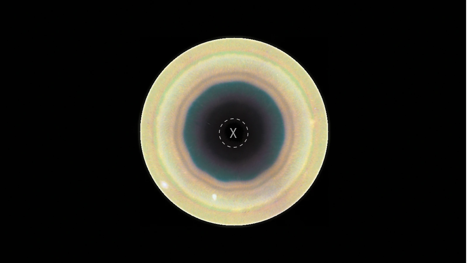 Hubble Space Telescope view looking down on Saturn's south pole, showing a dark 10-sided decagon pattern surrounded by tan and orange cloud bands