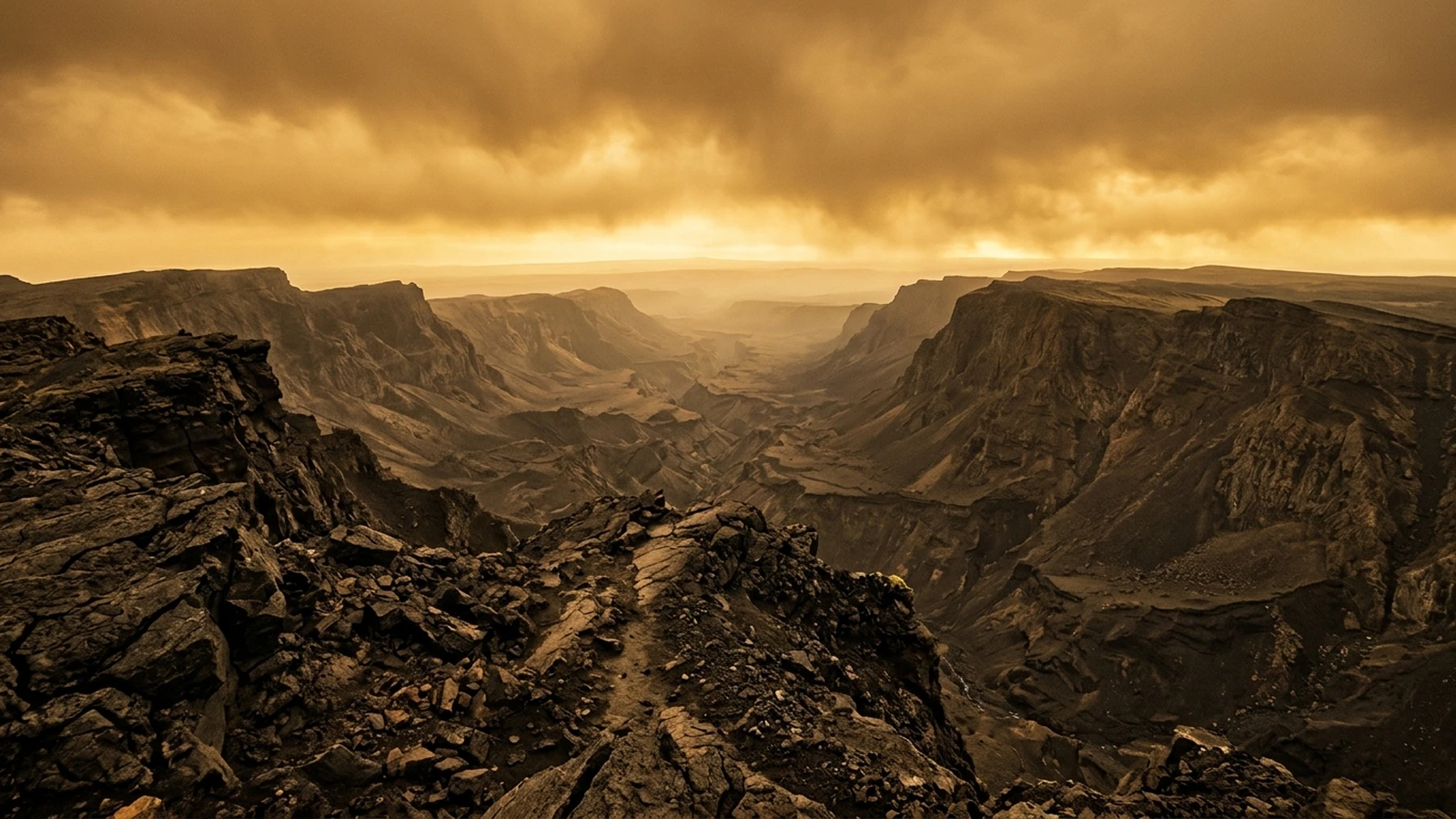 Artist's view of a vast rift valley on Venus, with steep raised flanks either side of a deep canyon under a thick orange sky