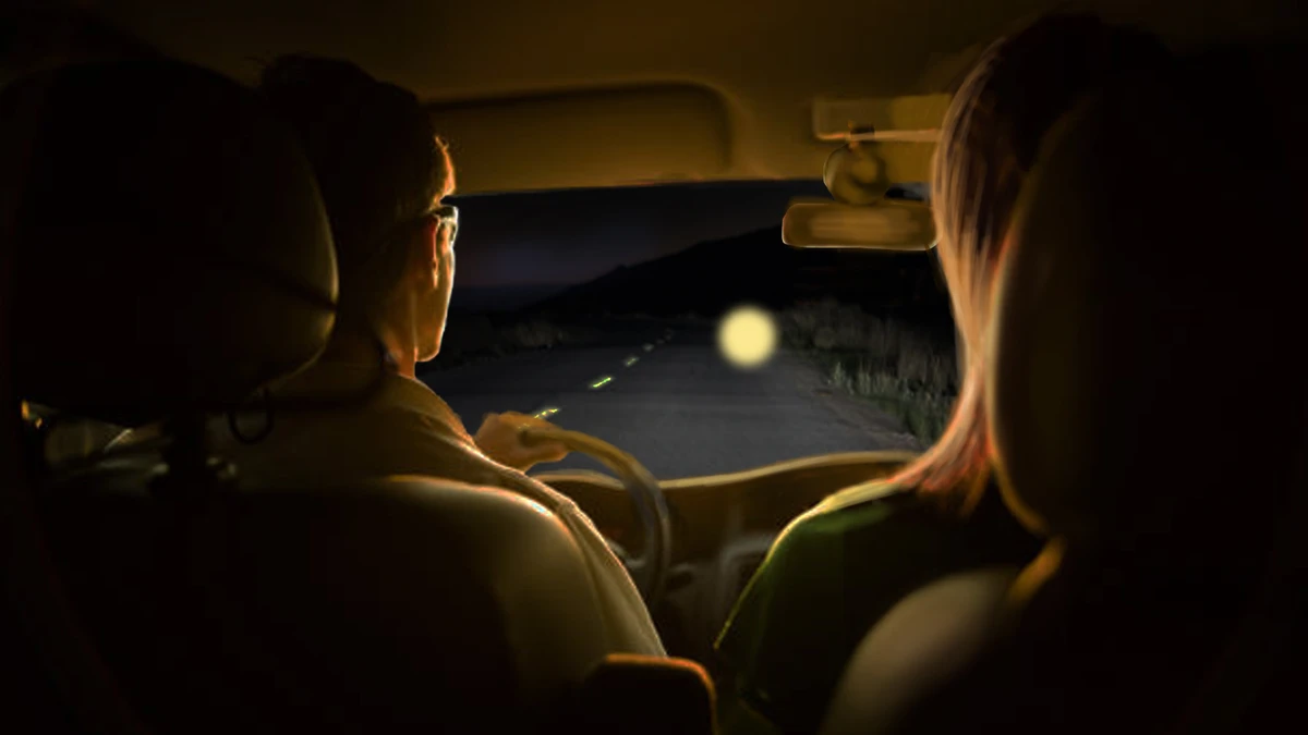 FBI digital rendering of two agents inside a vehicle at night watching a glowing orb hovering on the road ahead