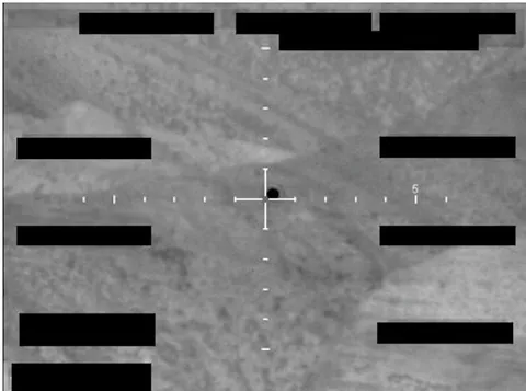 Redacted sensor image with a crosshair targeting an object.
