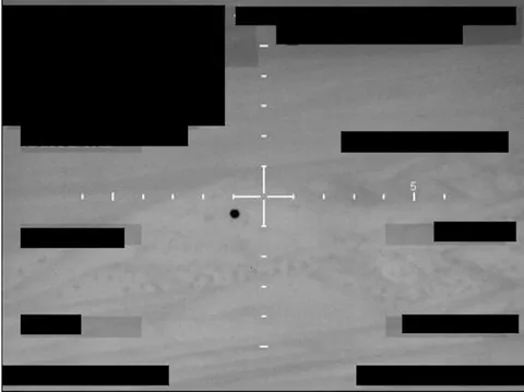 Redacted sensor image with a crosshair targeting an object.
