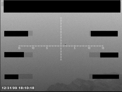 Redacted sensor image with a targeting reticle.
