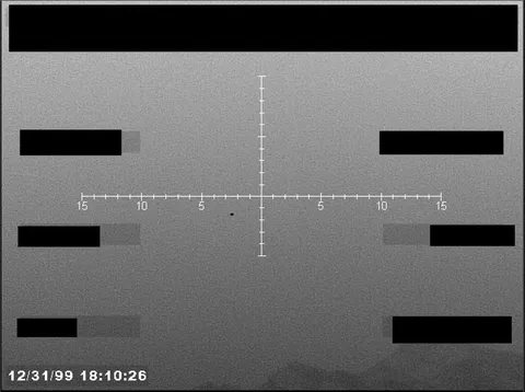 Redacted sensor image with a targeting reticle.