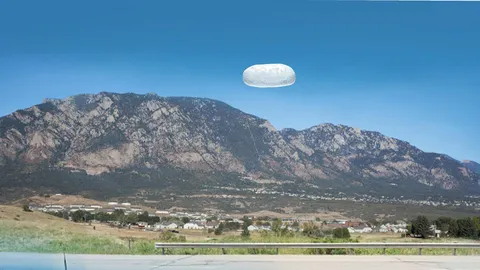 Rendering of an object over a mountain landscape.