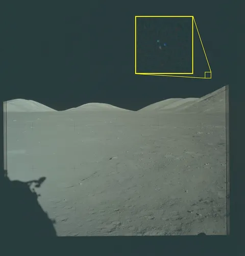 Photograph of the lunar surface showing astronaut shadows and a magnified callout of an object in the sky.